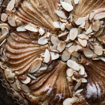 Pear frangipane tart sprinkled with sliced almonds.