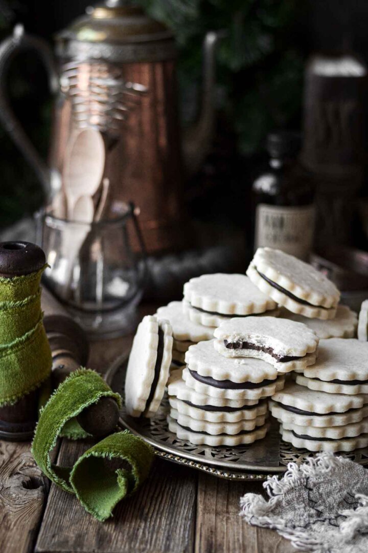 Anise chocolate sandwich cookies, stacked on a silver tray.