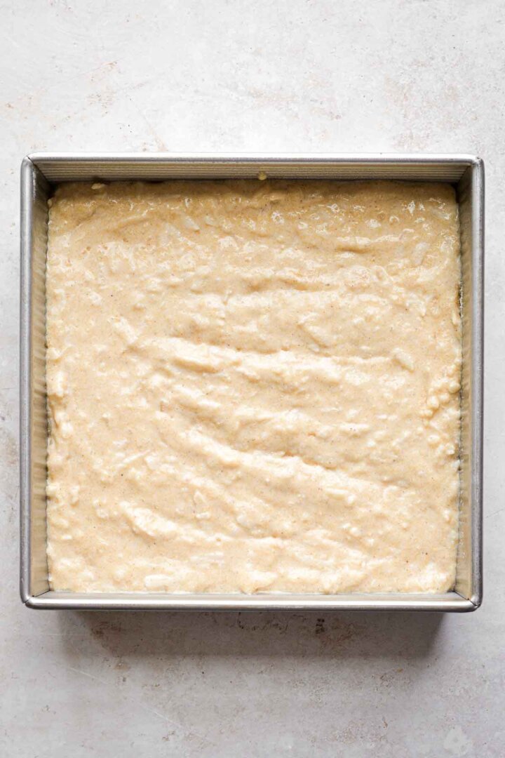 Step 5 for making apple cornbread crumb cake - batter in baking pan.