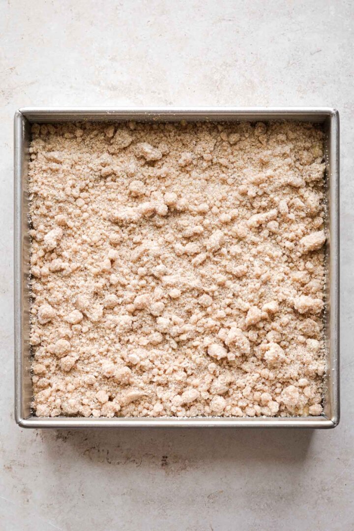 Step 6 for making apple cornbread crumb cake - adding crumb topping.