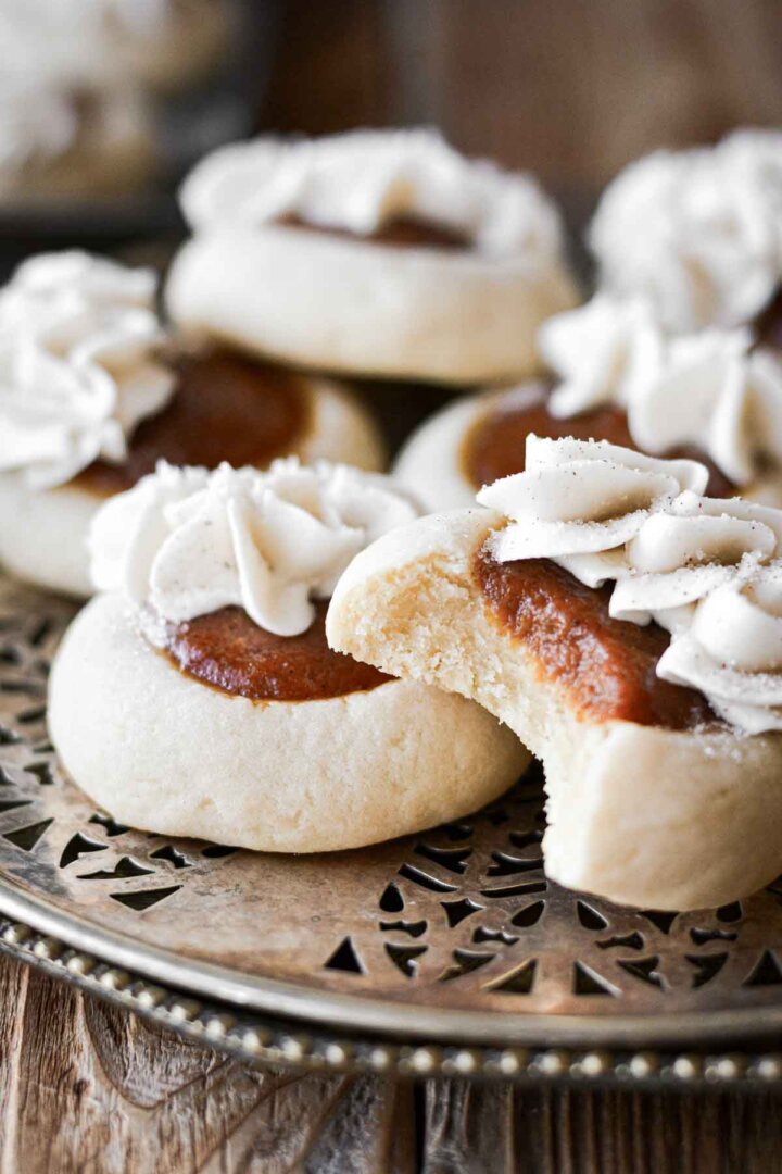 Pumpkin pie cookies, one with a bite taken.
