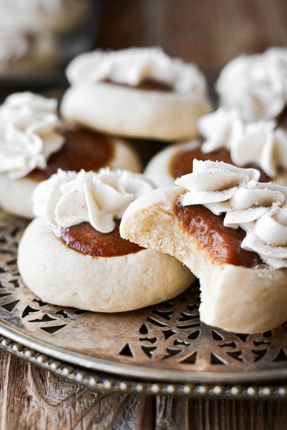 Pumpkin pie cookies, one with a bite taken.