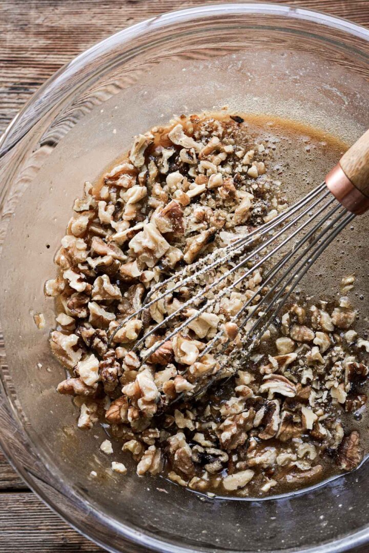 Step 3 for making walnut pie - adding chopped walnuts.
