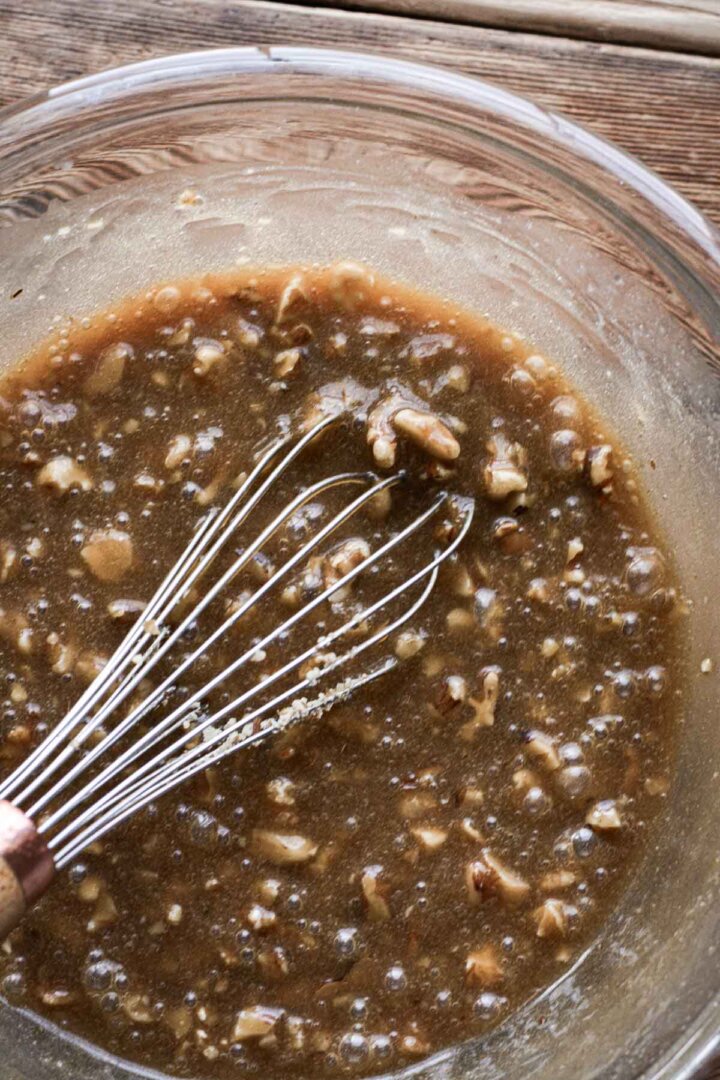 Step 4 for making walnut pie - adding chopped walnuts.