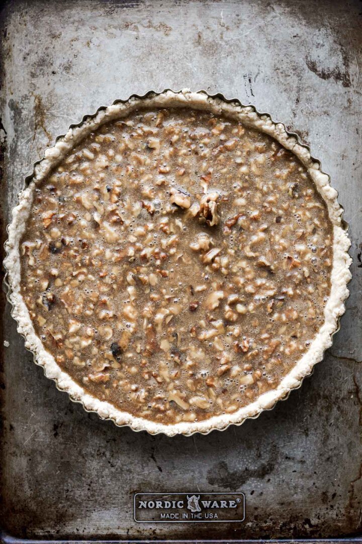 Step 7 for making walnut pie - unbaked filling in crust.