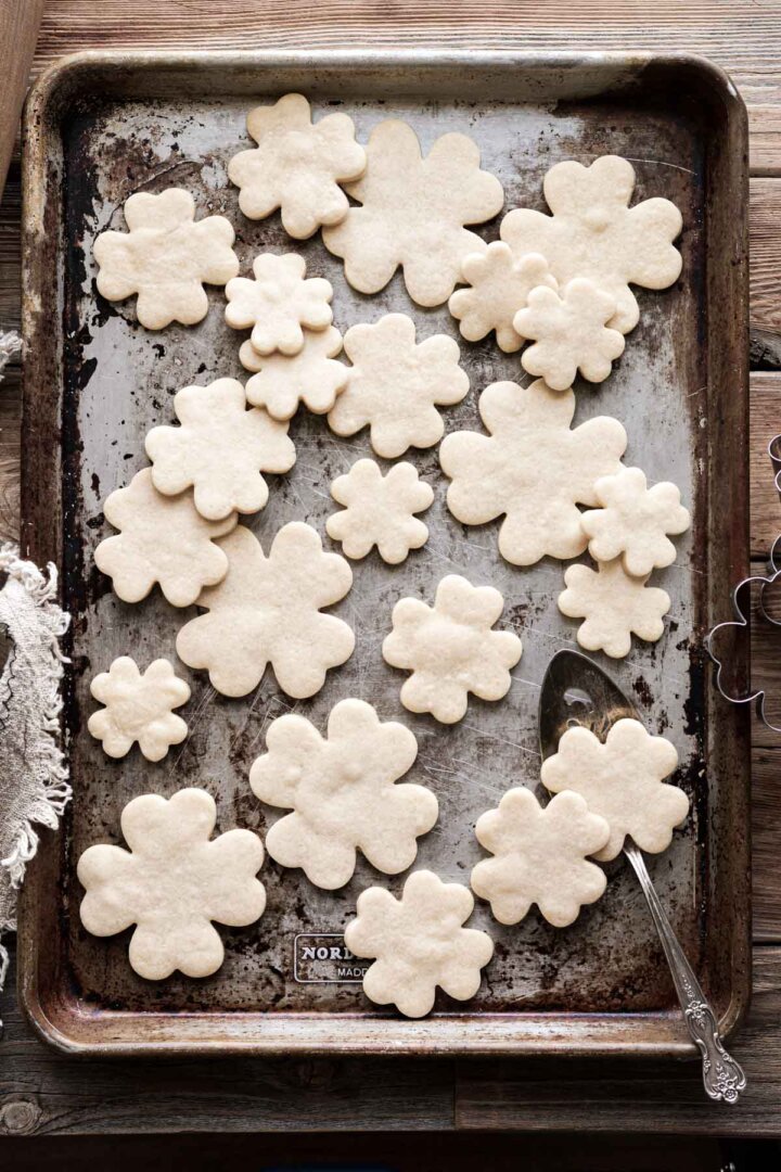 Unfrosted four leaf clover cutout cookies.