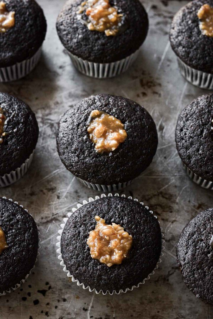 Chocolate cupcakes filled with caramel coconut pecan frosting.