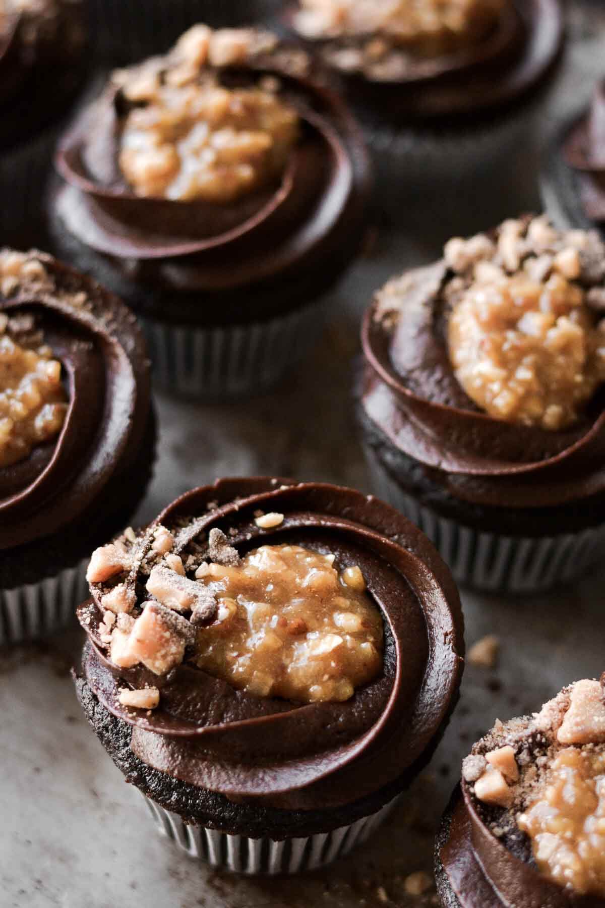 German chocolate cupcakes with chocolate buttercream, coconut caramel filling and toffee bits.