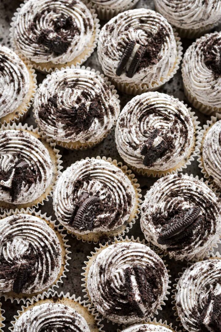 Cookies and cream cupcakes decorated with crushed Oreos.