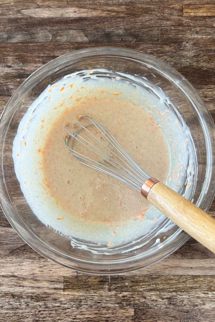 Step 2 for making carrot cake ice cream - whisking carrots, spices and milk.