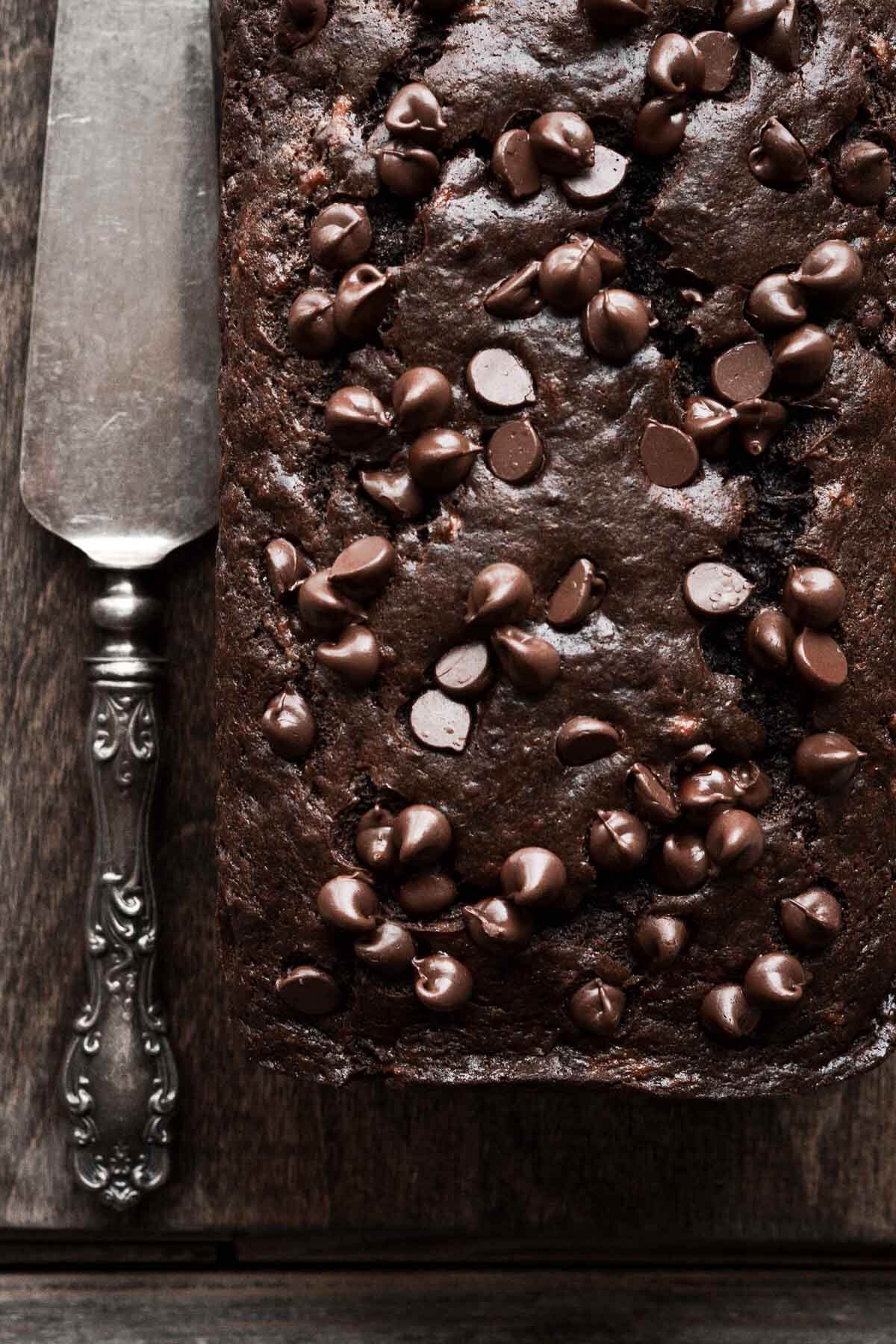 Chocolate banana bread with chocolate chips on top.