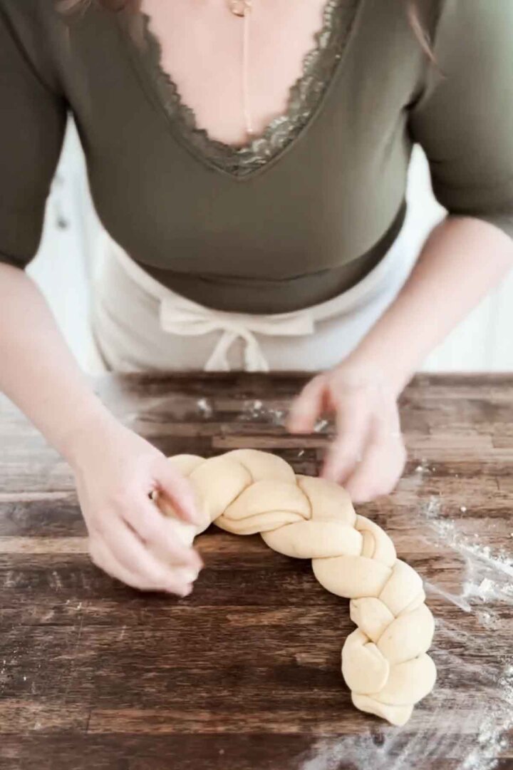 Step 7 for making Easter bread - shaping braided dough into loaf.