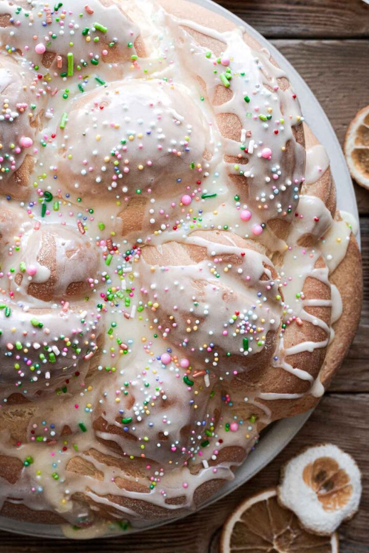 Icing and sprinkles on braided bread.