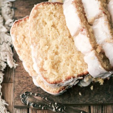 Slices of lemon loaf cake on a wooden board.