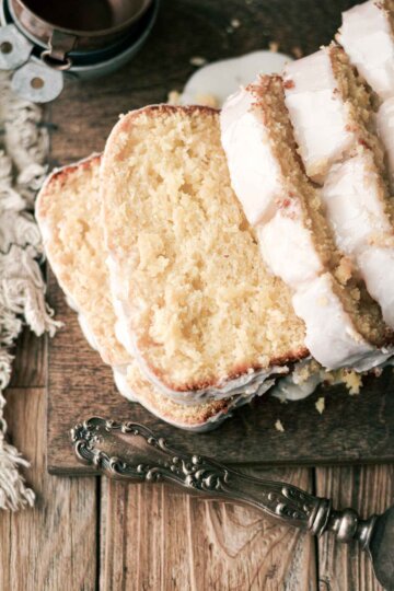 Slices of lemon loaf cake on a wooden board.