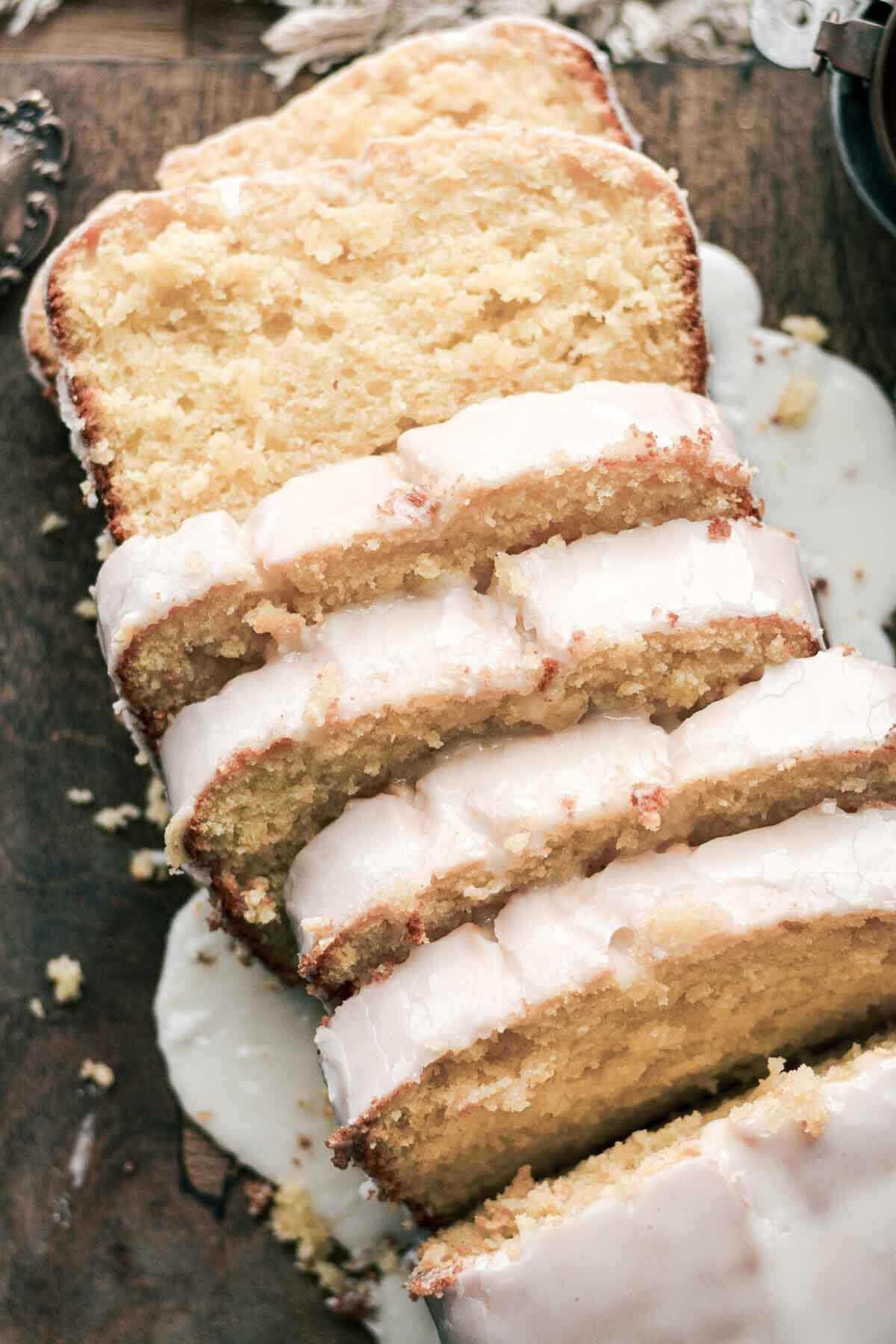 Slices of lemon loaf cake with dripping icing.
