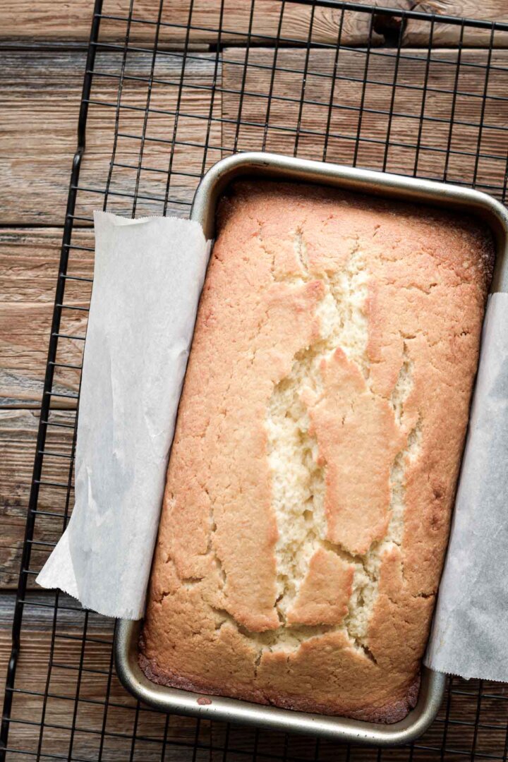 Freshly baked lemon bread on a cooling rack.