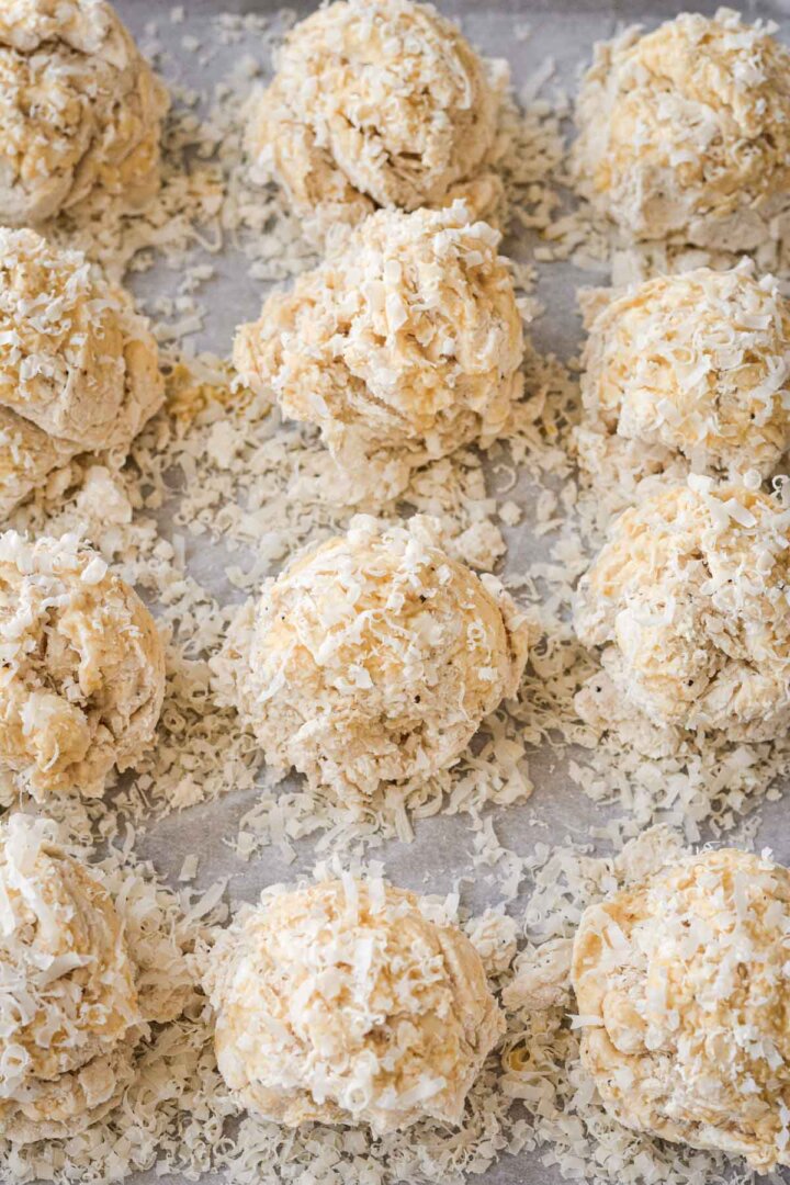 Unbaked drop biscuits sprinkled with parmesan cheese.