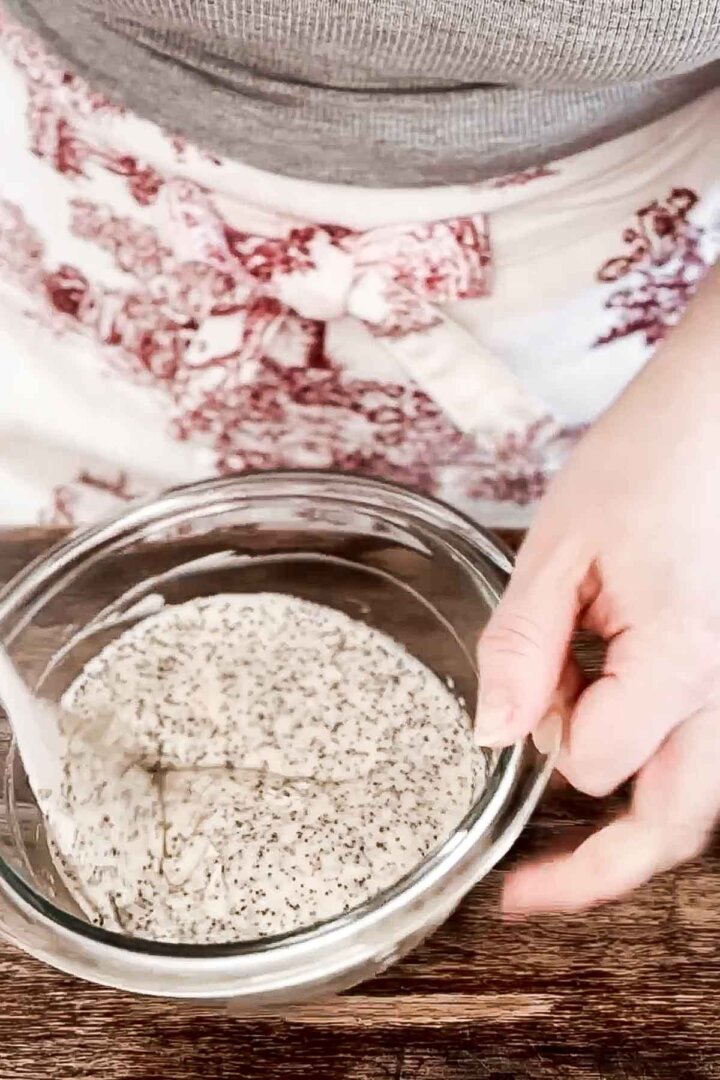 Adding poppy seeds to cake batter.