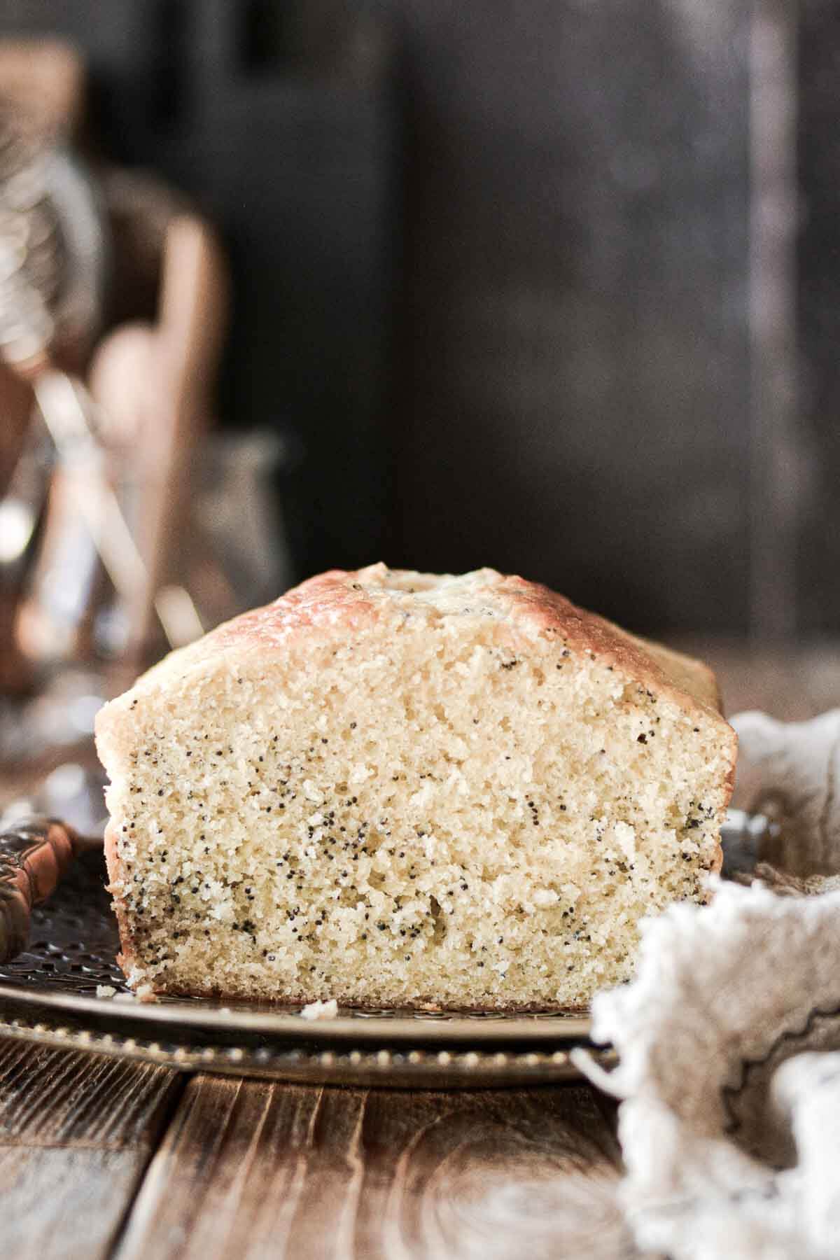 Poppy seed loaf cake with a slice cut.