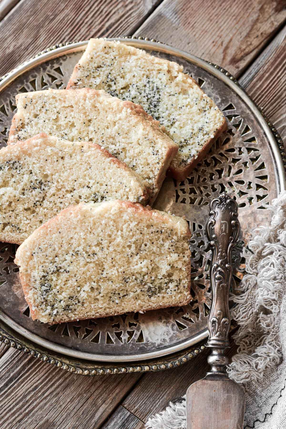Slices of poppy seed cake on a vintage plate.