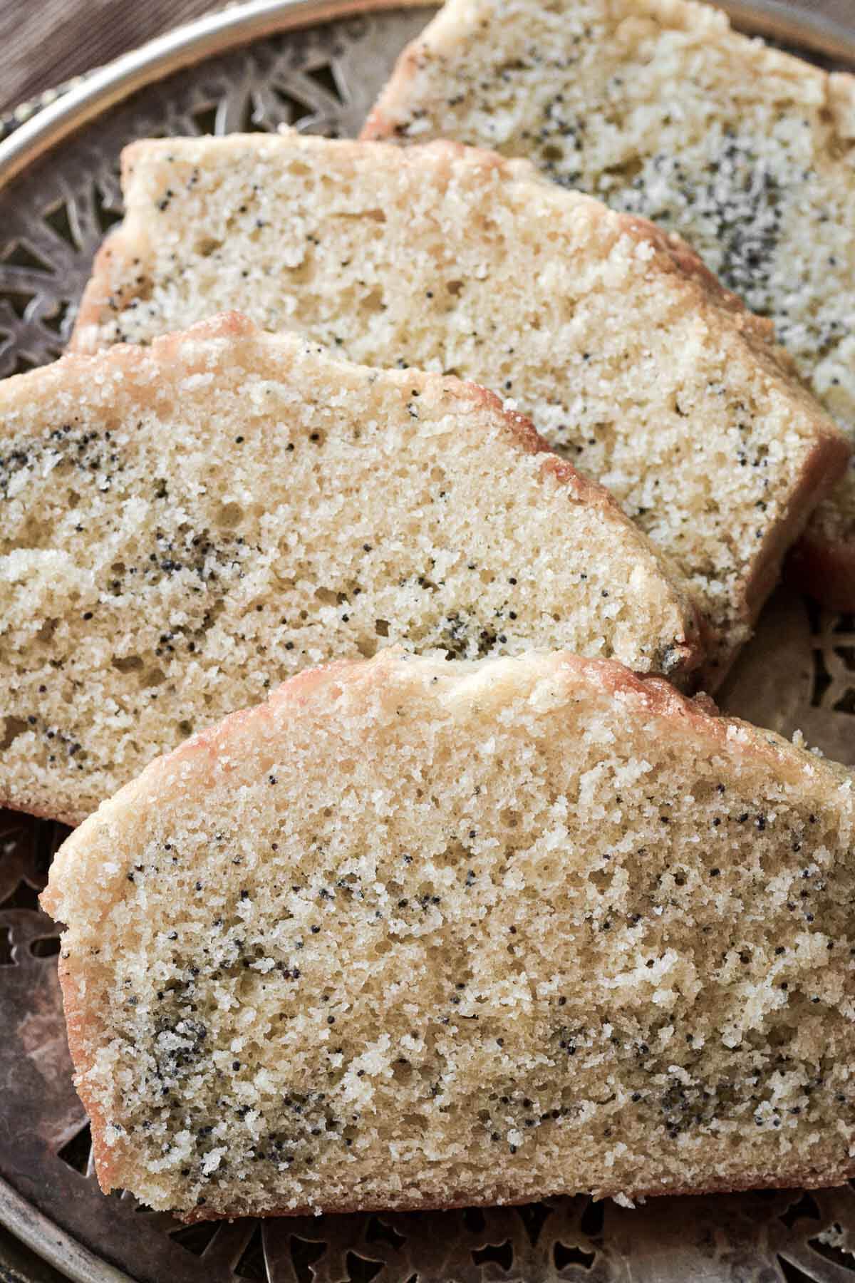 Slices of poppy seed cake on a vintage plate.
