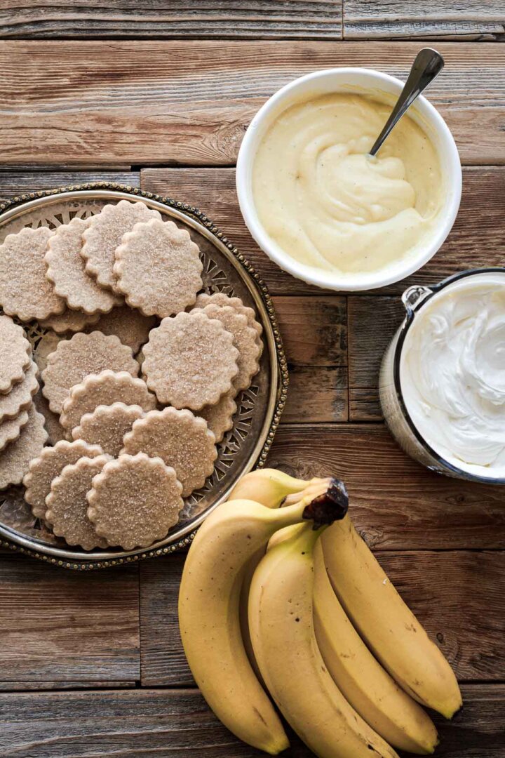 Bananas, cookies, custard, and whipped cream, for making banana pudding.