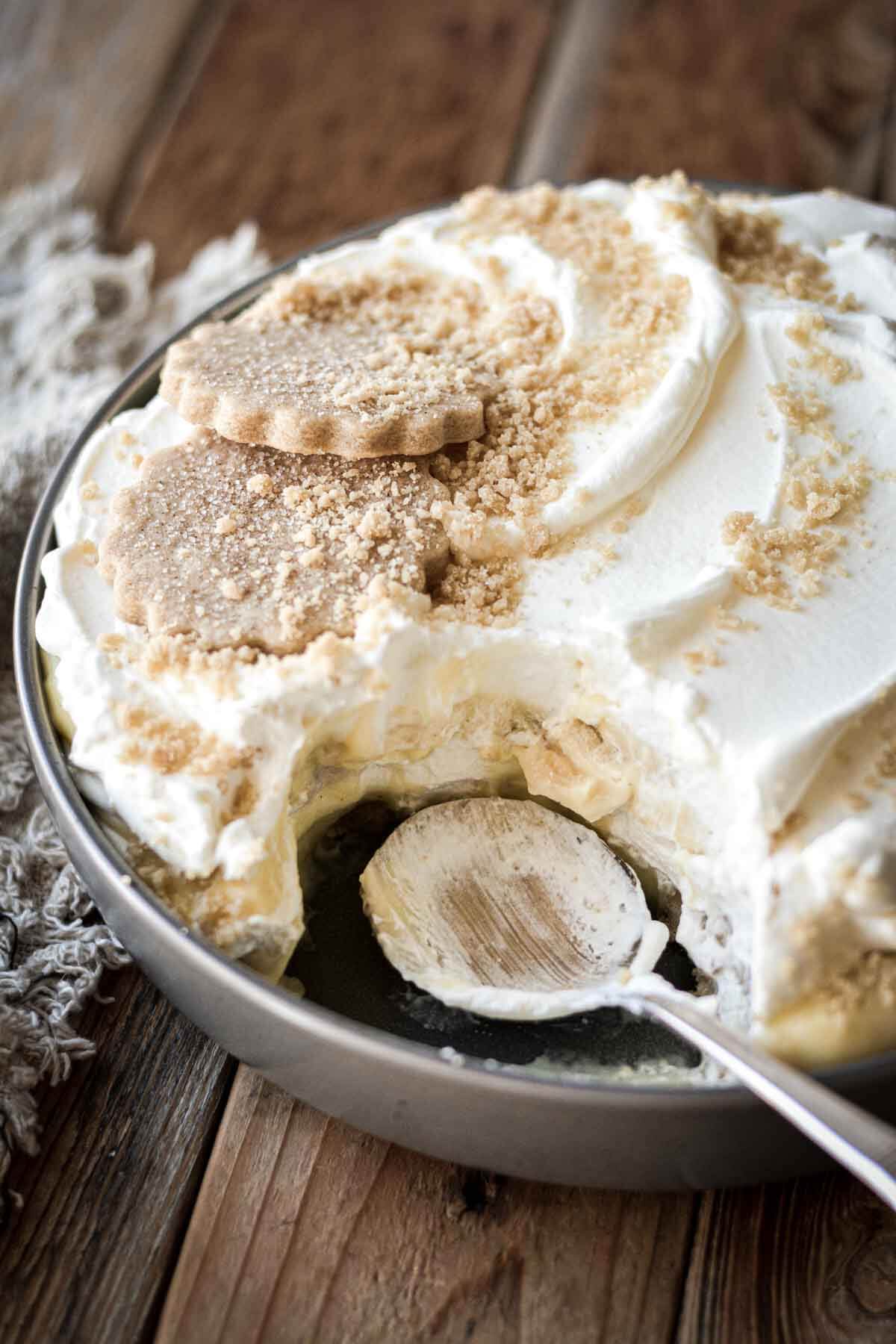 Serving dish of banana pudding, with a spoonful taken.