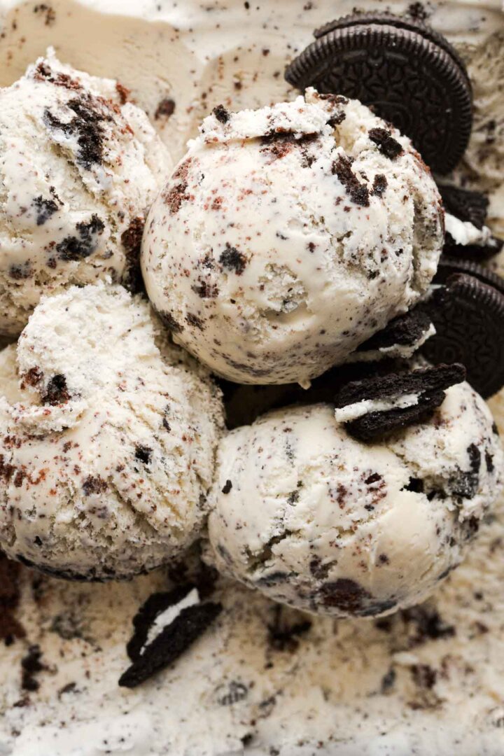 Scoops of cookies and cream ice cream with broken Oreos.