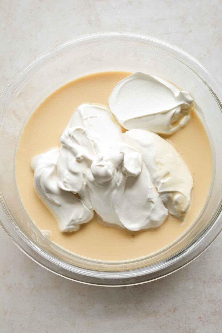 Whipped cream added to lemon ice cream mixture.