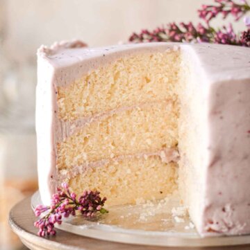 Lemon cake with blueberry buttercream, cut to show the layers inside.