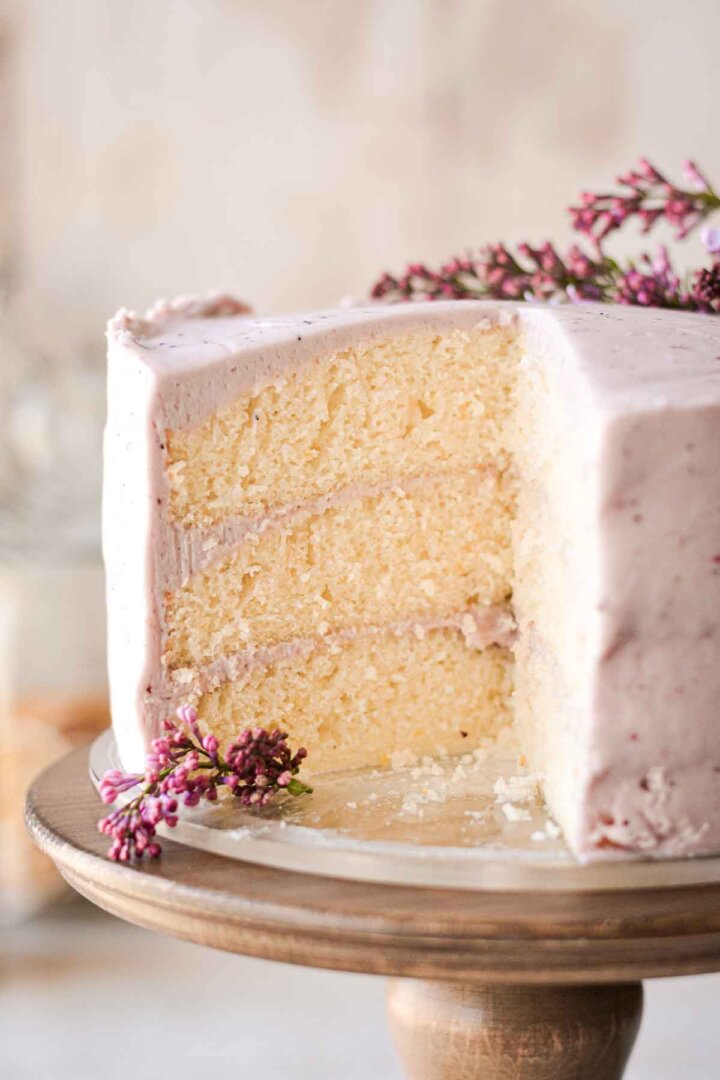 Lemon cake with blueberry buttercream, cut to show the layers inside.