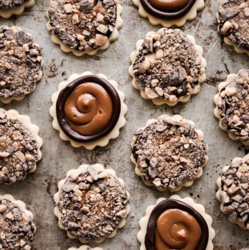 Millionaire's shortbread cookies with chocolate ganache, dulce de leche, and toffee bits.