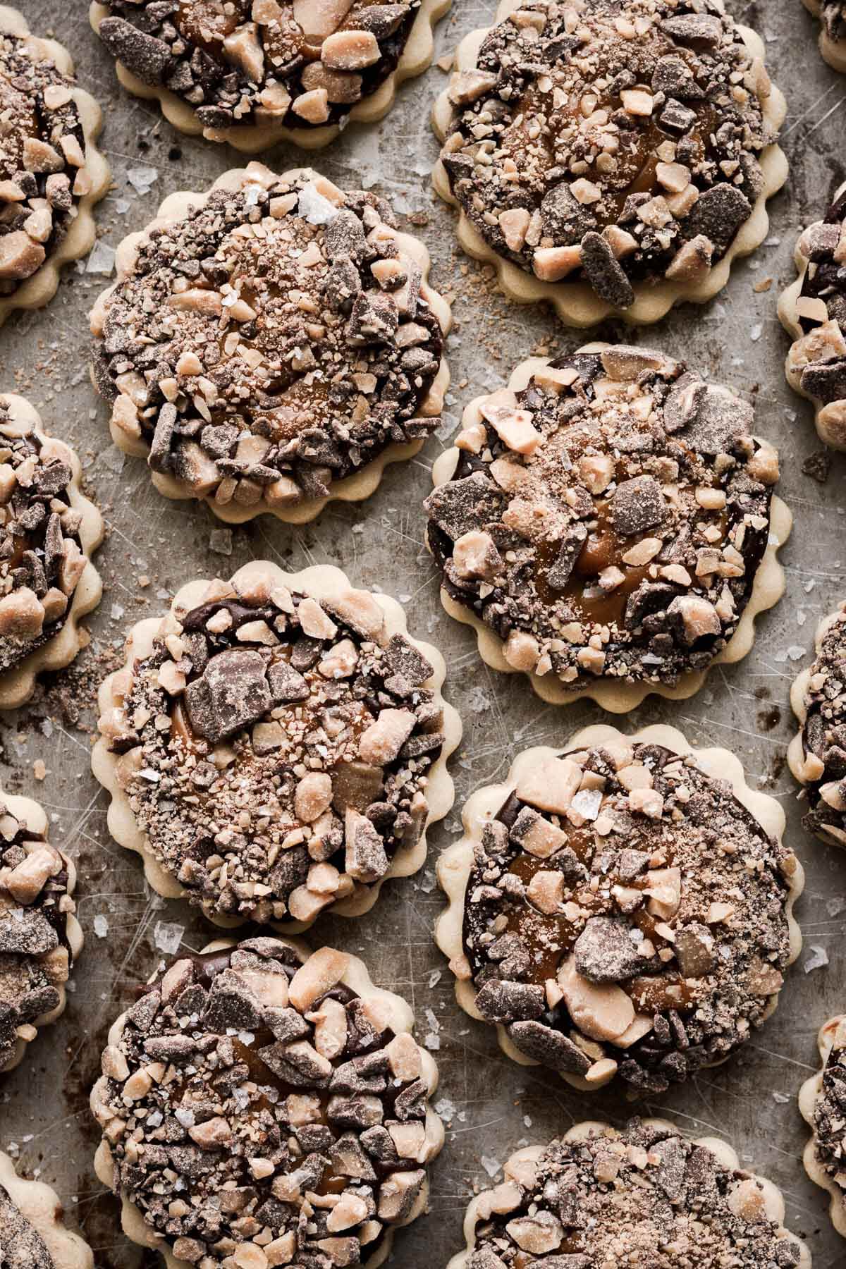 Millionaire's shortbread cookies with chocolate ganache, dulce de leche, and toffee bits.