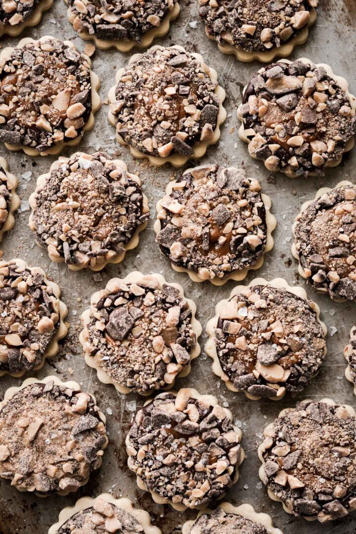 Millionaire's shortbread cookies with chocolate ganache, dulce de leche, and toffee bits.