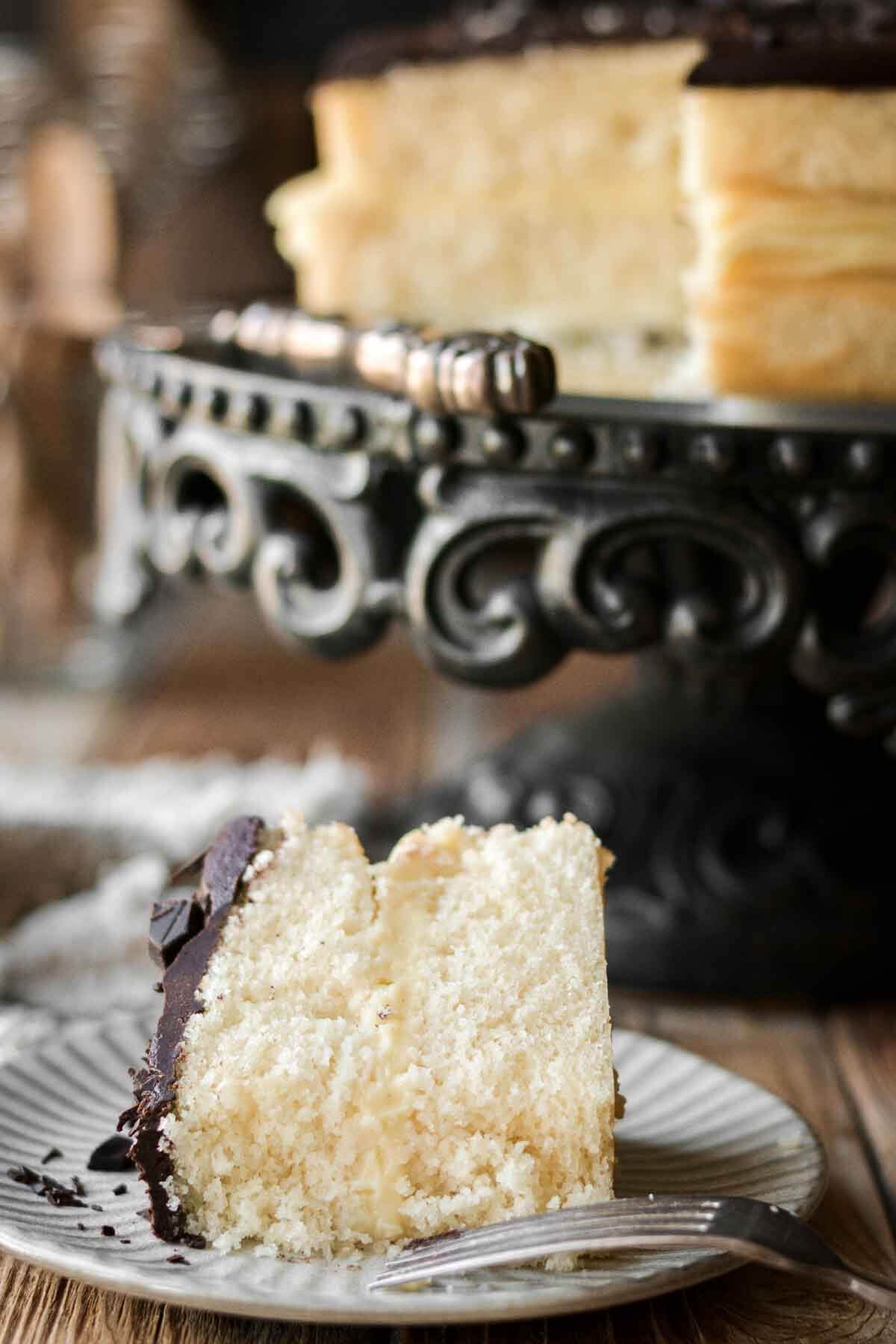 Slice of Boston cream pie cake on a plate.