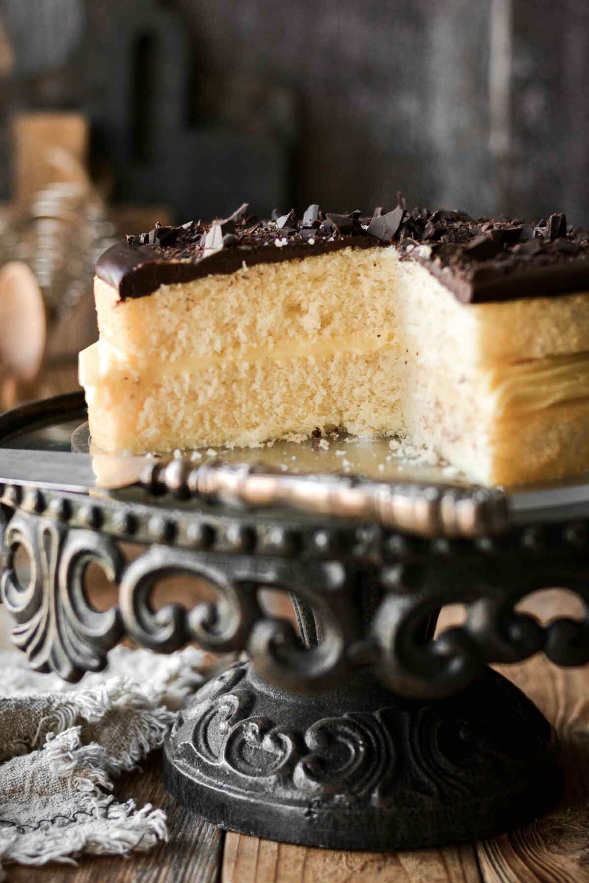 Boston cream pie, with a slice cut to show the layers.