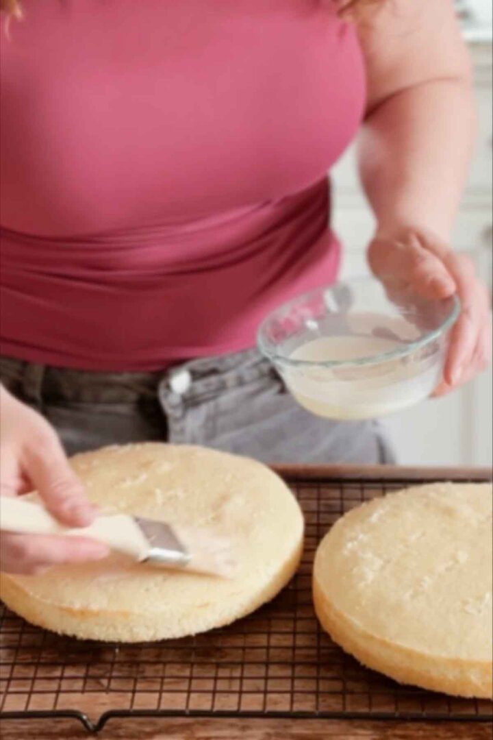 Brushing milk over vanilla cakes.
