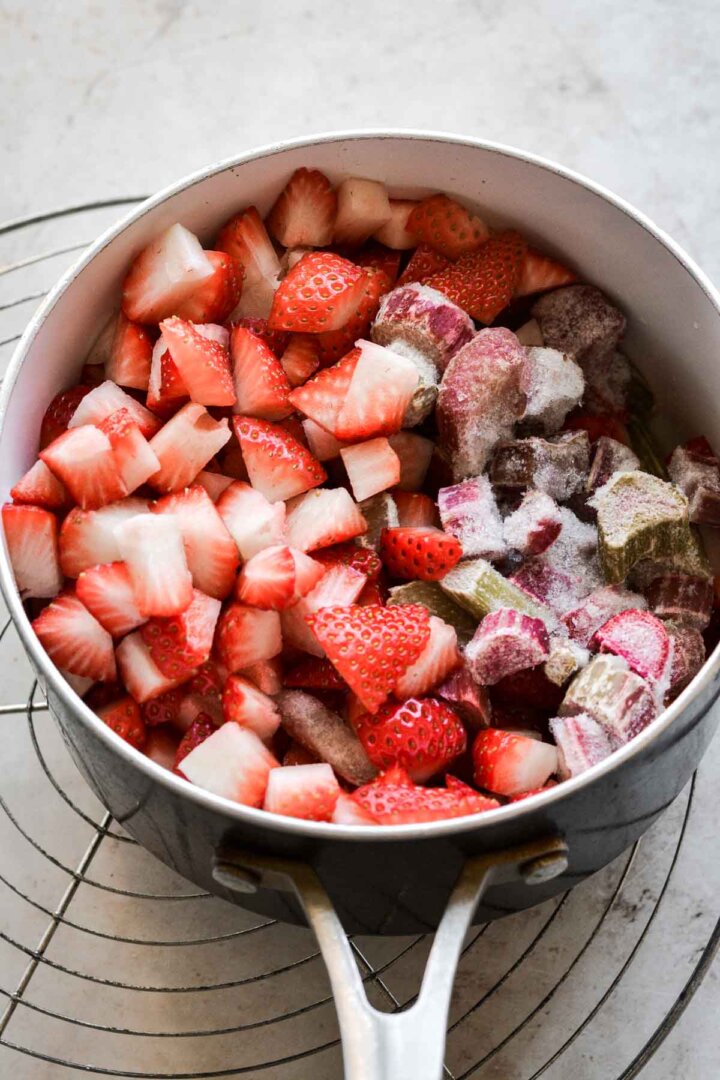Chopped strawberries and rhubarb in a saucepan.