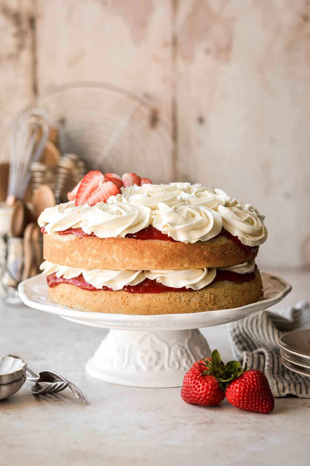 Strawberry chamomile cake - a naked cake with layers of strawberry rhubarb compote and honey orange buttercream.