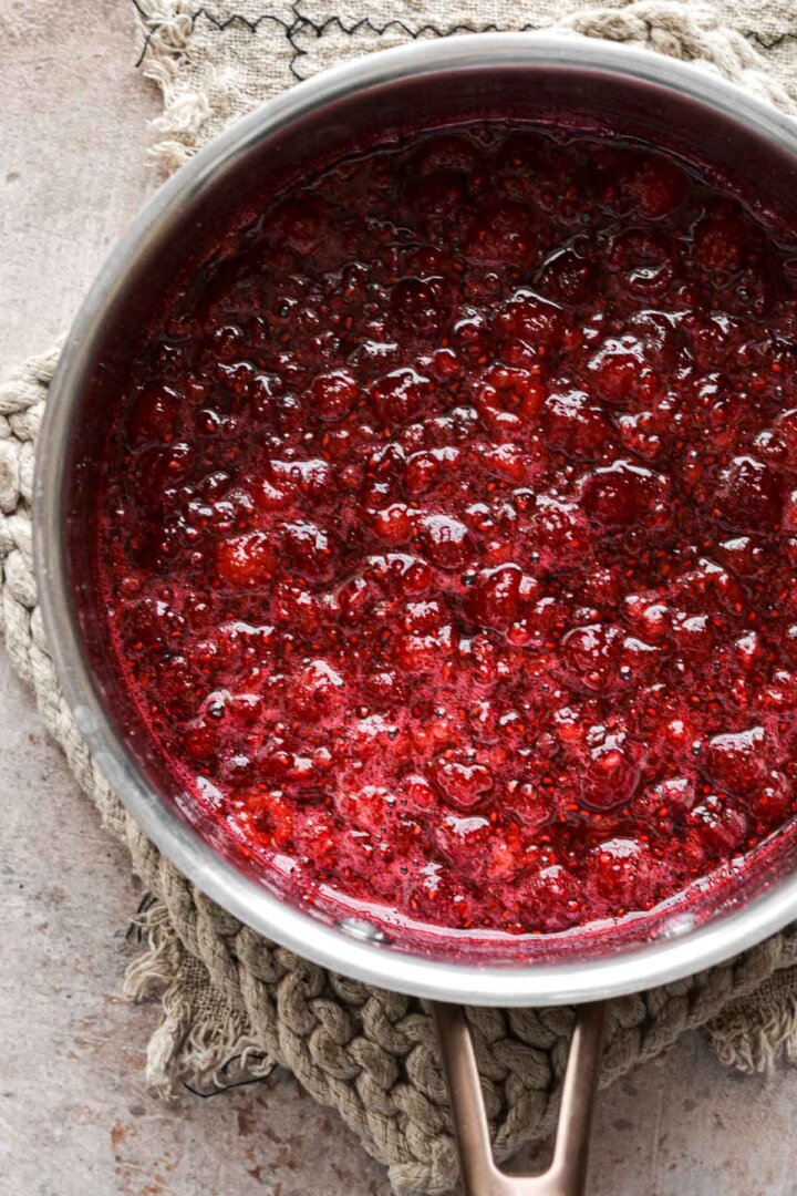 Step 2 for making raspberry ice cream - simmer raspberries with sugar.