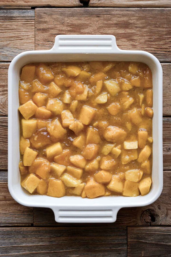 Step 2 for making mango cobbler - cooked mango filling in a baking dish.