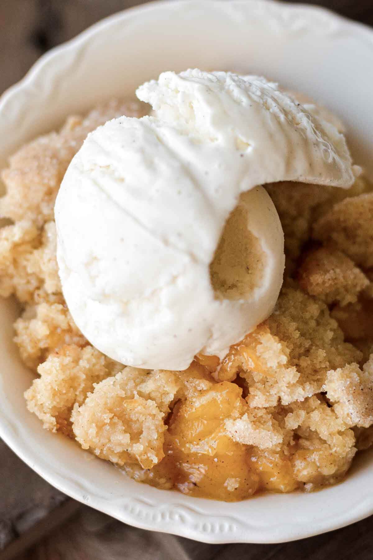 Mango cobbler topped with ice cream.
