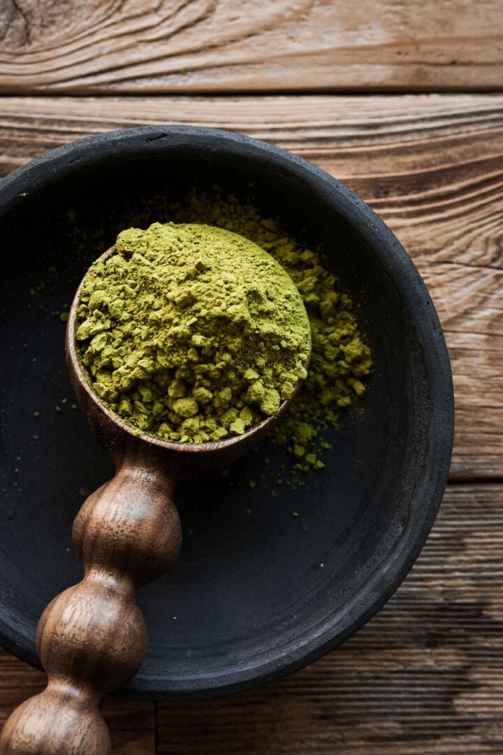 Wooden spoon of matcha green tea powder.