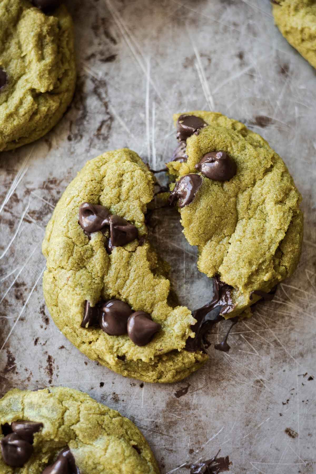 Matcha chocolate chip cookie broken in half.