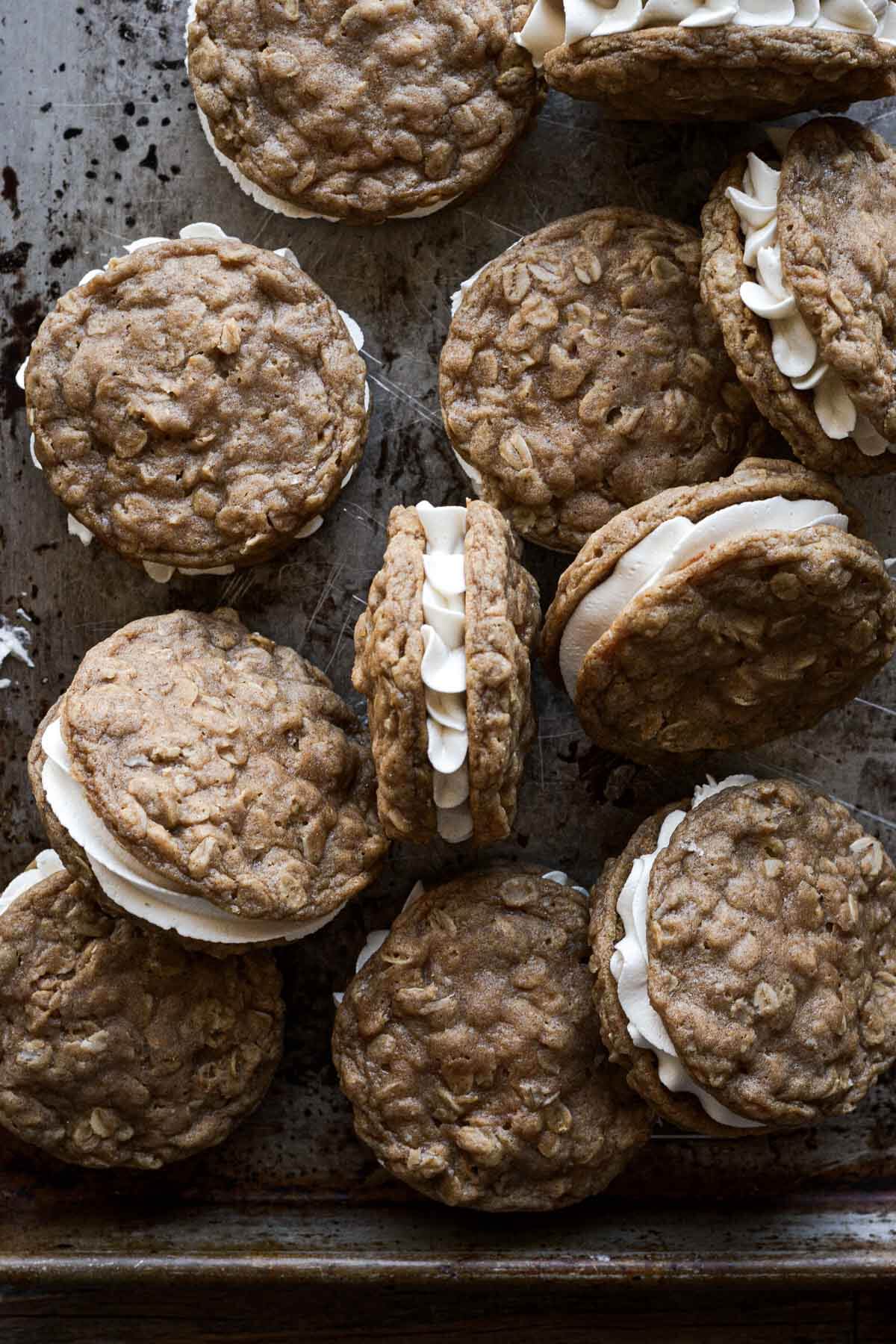Homemade oatmeal cream pies on a baking sheet.