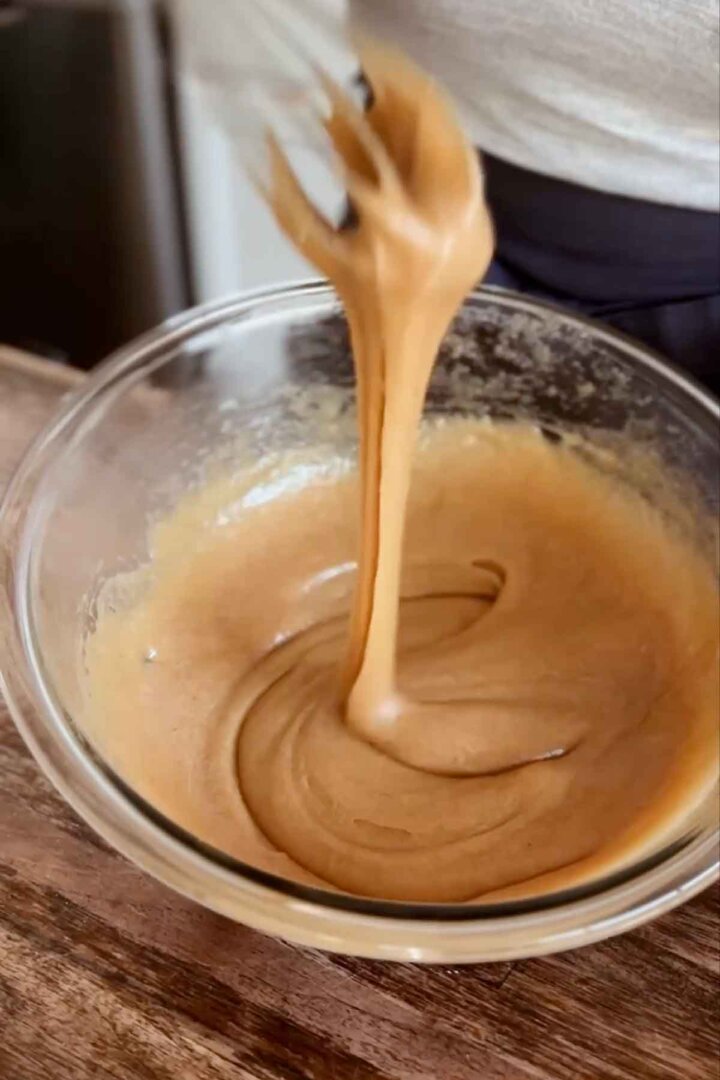 Step 3 for making oatmeal cookies - whisking in eggs and vanilla.