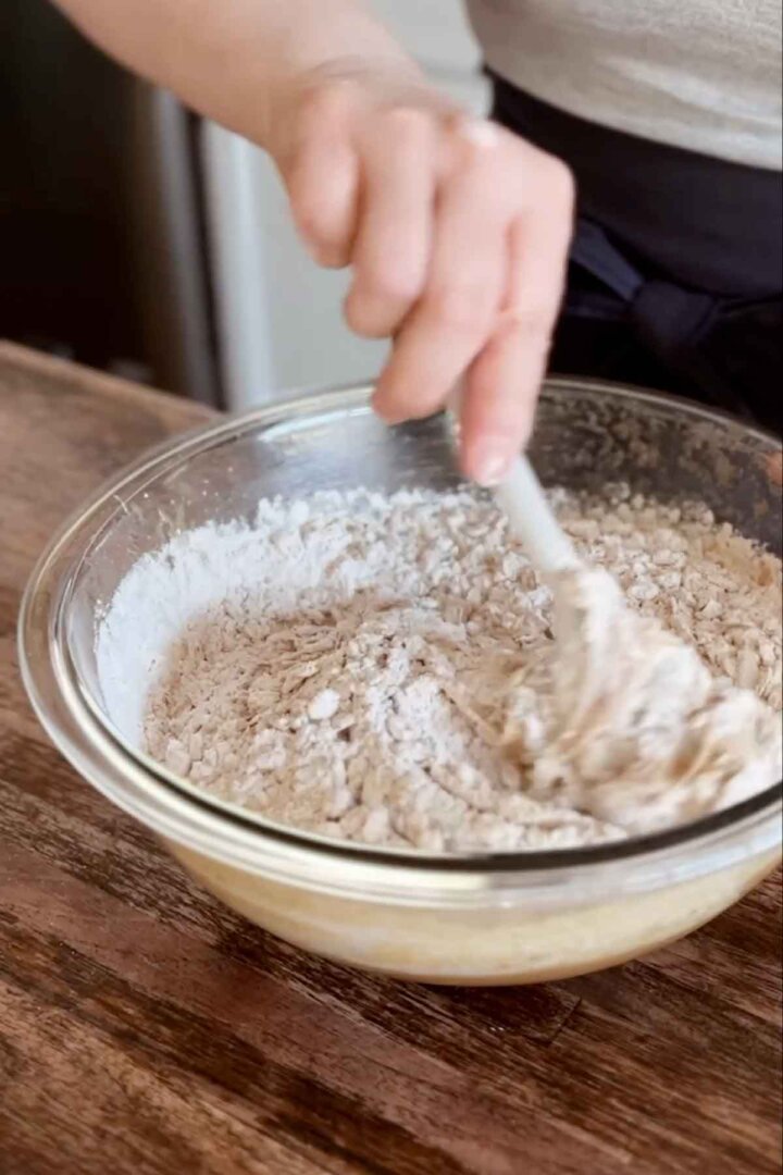 Step 4 for making oatmeal cookies - adding dry ingredients.