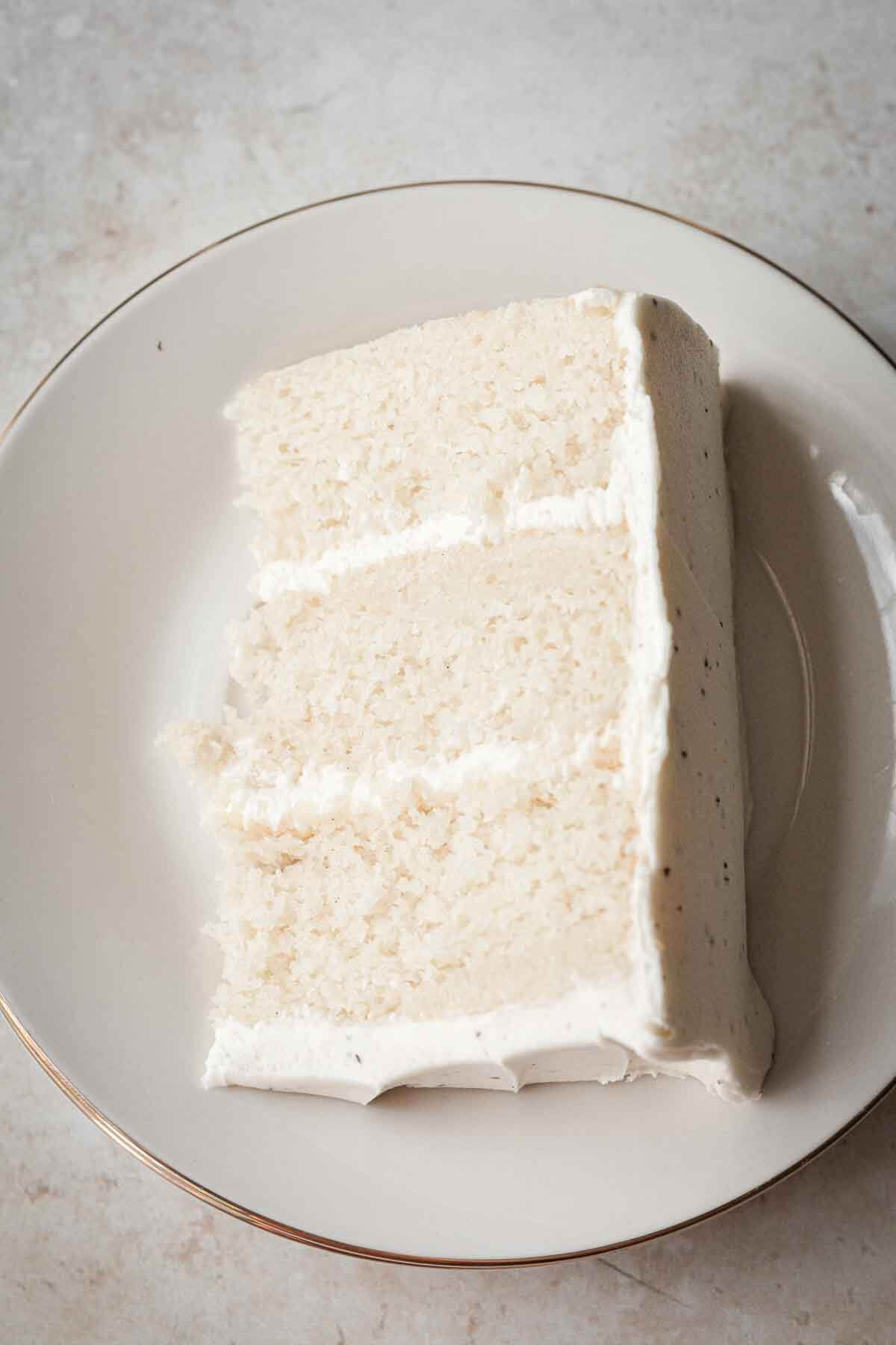 Slice of white velvet cake on a plate.