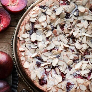 Almond plum cake with sliced almonds on top.